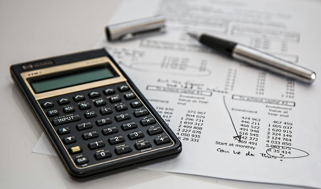 calculator-calculation-insurance-finance-53621-53621 Close-up of financial documents with calculator and pen, ideal for business management themes.